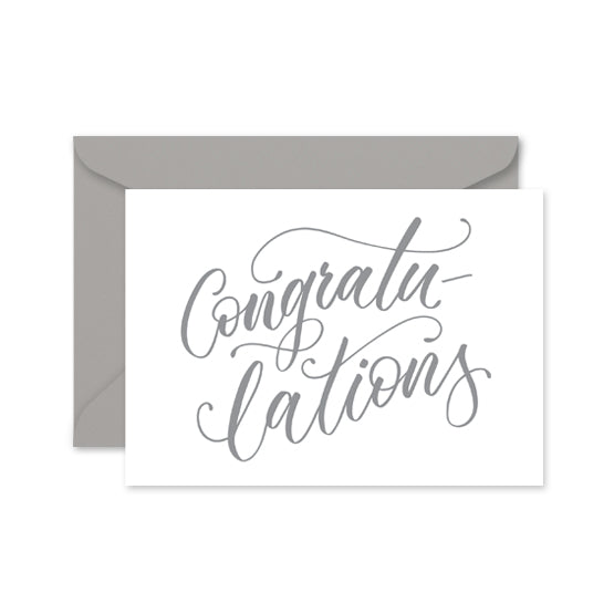 greeting card with grey calligraphy with the word 'congratulations' on a grey envelope