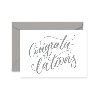 greeting card with grey calligraphy with the word 'congratulations' on a grey envelope