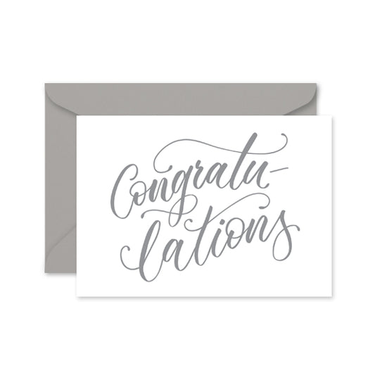 greeting card with grey calligraphy with the word 'congratulations' on a grey envelope