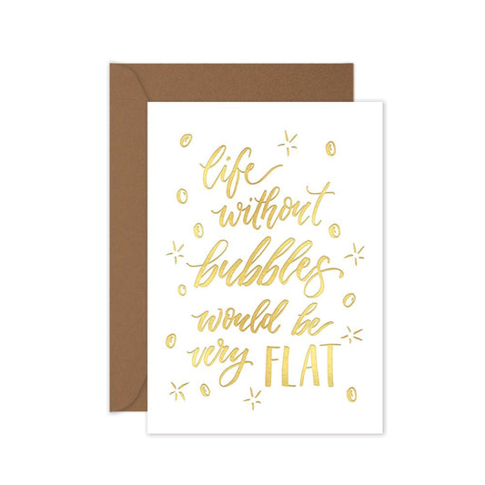 a gold foiled greeting card with the script 'life without bubbles would be very flat' with a brown kraft envelope